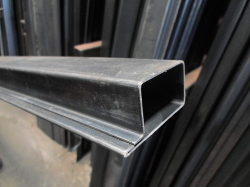 Rolamento de metal. tubos quadrados de aço compridos dobrados no chão